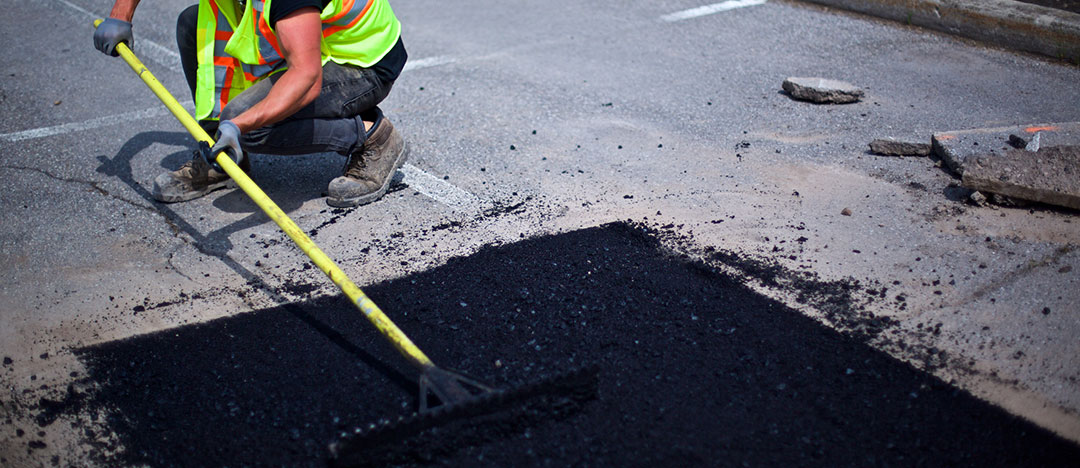 spreading the asphalt on the hole